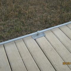 Galvanised steel kerb attached to concrete boardwalk.