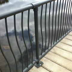 Powder coated steel fencing attached to concrete boardwalk
